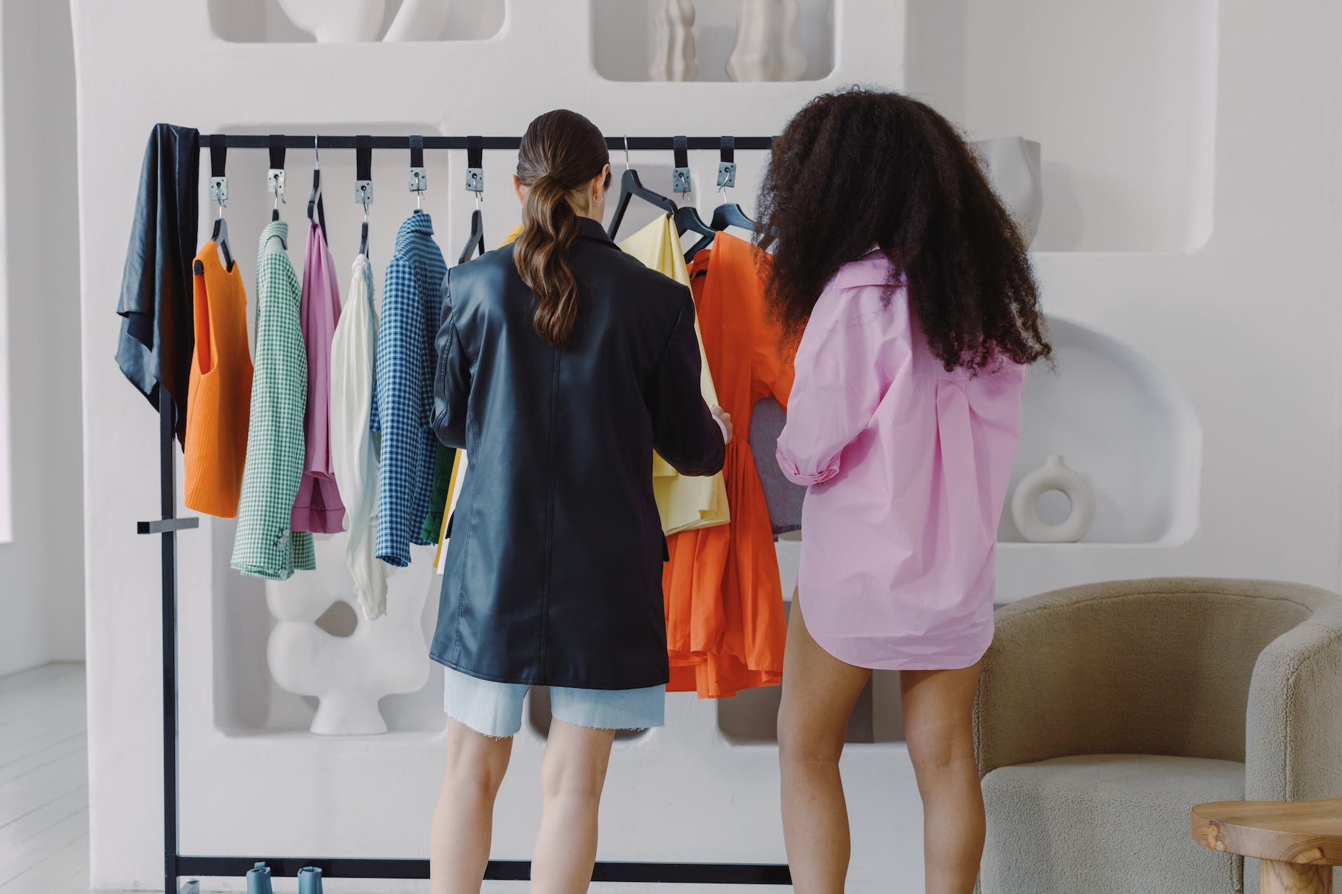 women looking at clothes on rack